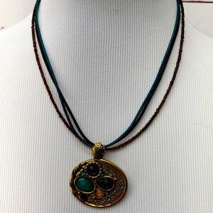 Necklace with blue and brown cords and multicolor stones
